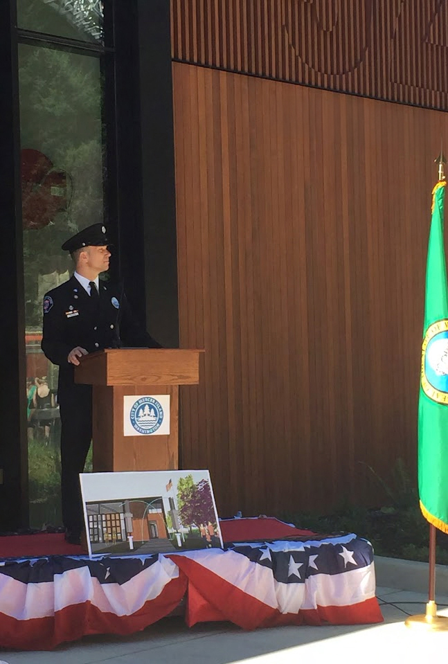 Ray Austin in uniform speaking at a podium